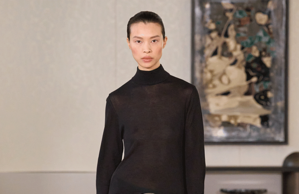 Model in a black top and turquoise skirt at the Altuzarra show