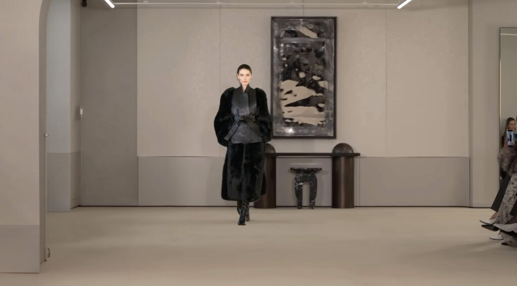 Model walking a runway inside The Woolworth