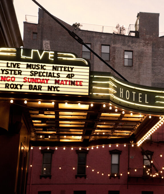The Roxy Hotel marquee lit at dusk advertising live music