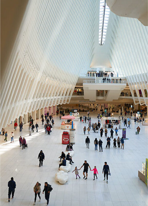 Crowds beneath the white ribbed vaults of the Oculus transit hall