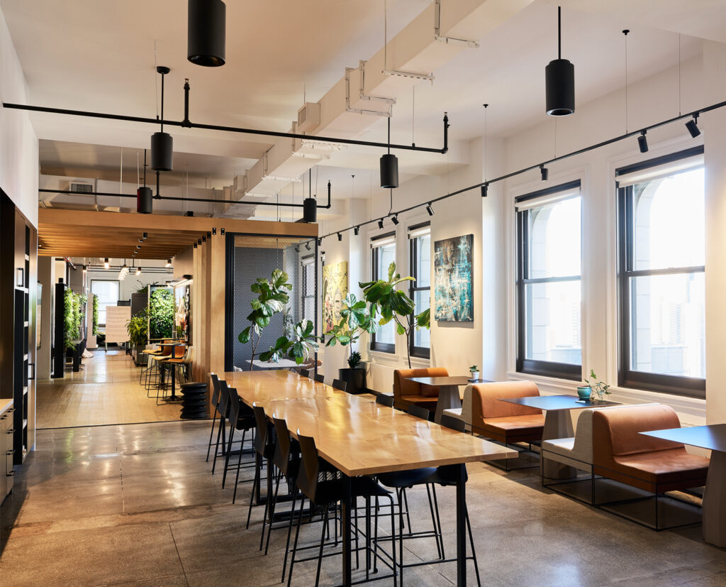 Full-floor office with a long communal table and city views