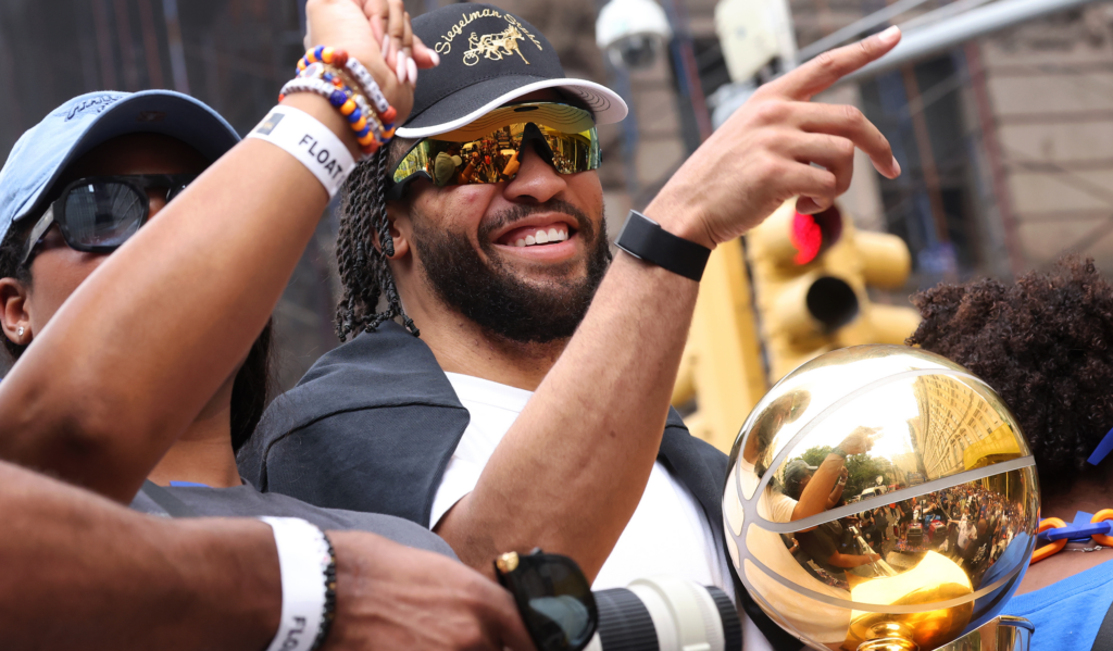 Knicks player rides in the championship parade with a trophy