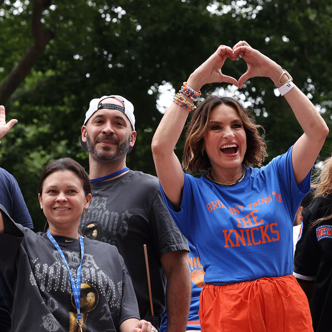 Knicks fans make a heart shape with their hands