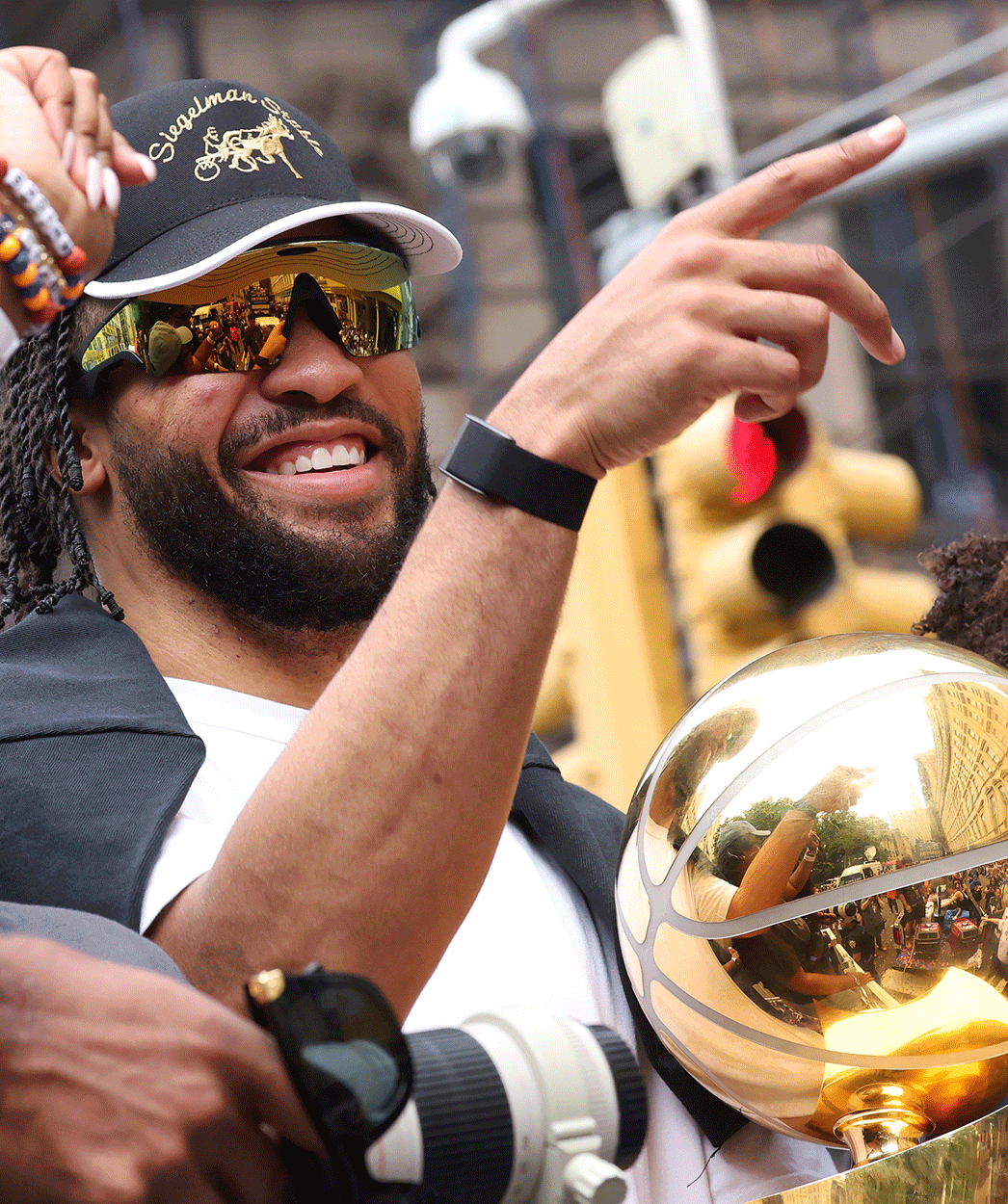 Knicks player rides in the championship parade with a trophy