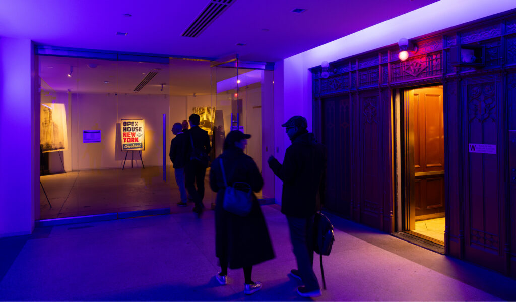 Guests walk through a purple-lit hall at The Woolworth