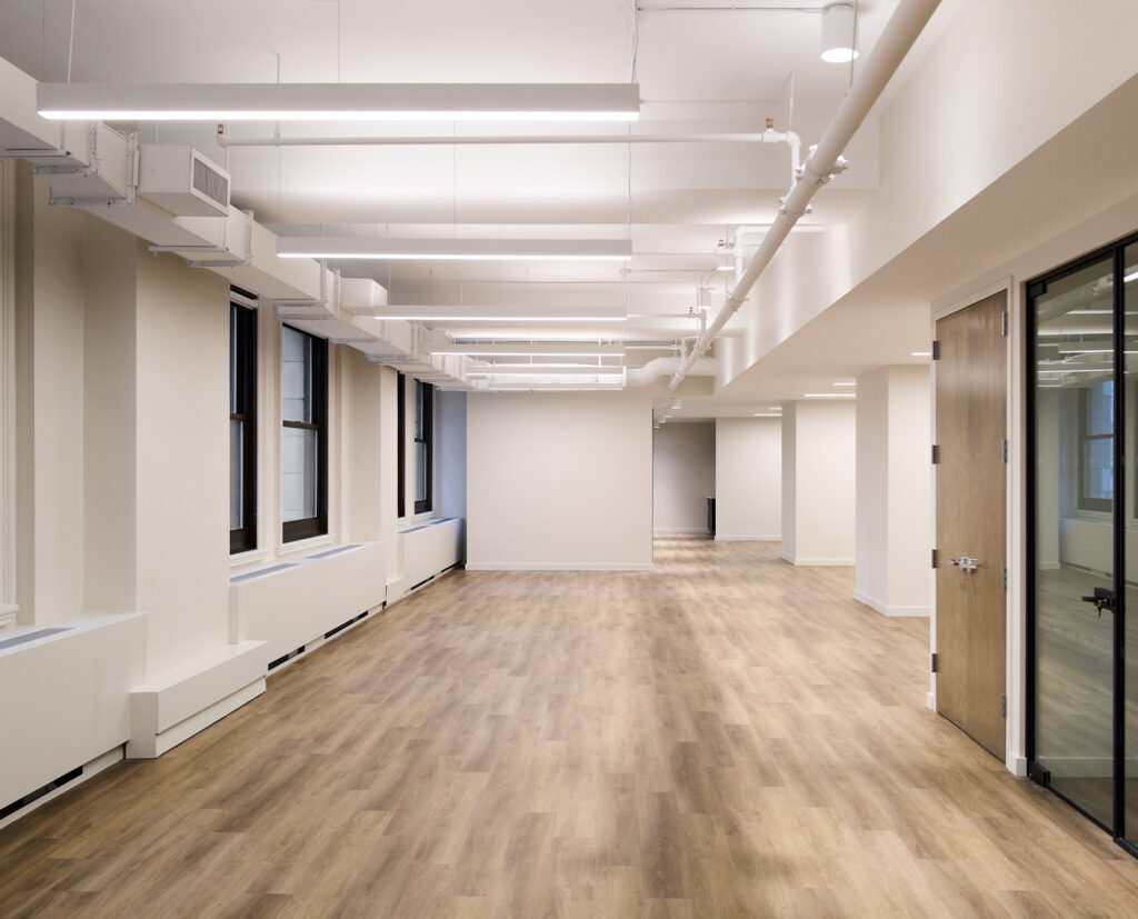 Pre-built office suite with wood floors and large windows