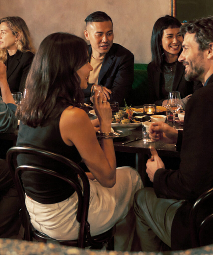 Guests dine together at an intimate restaurant table