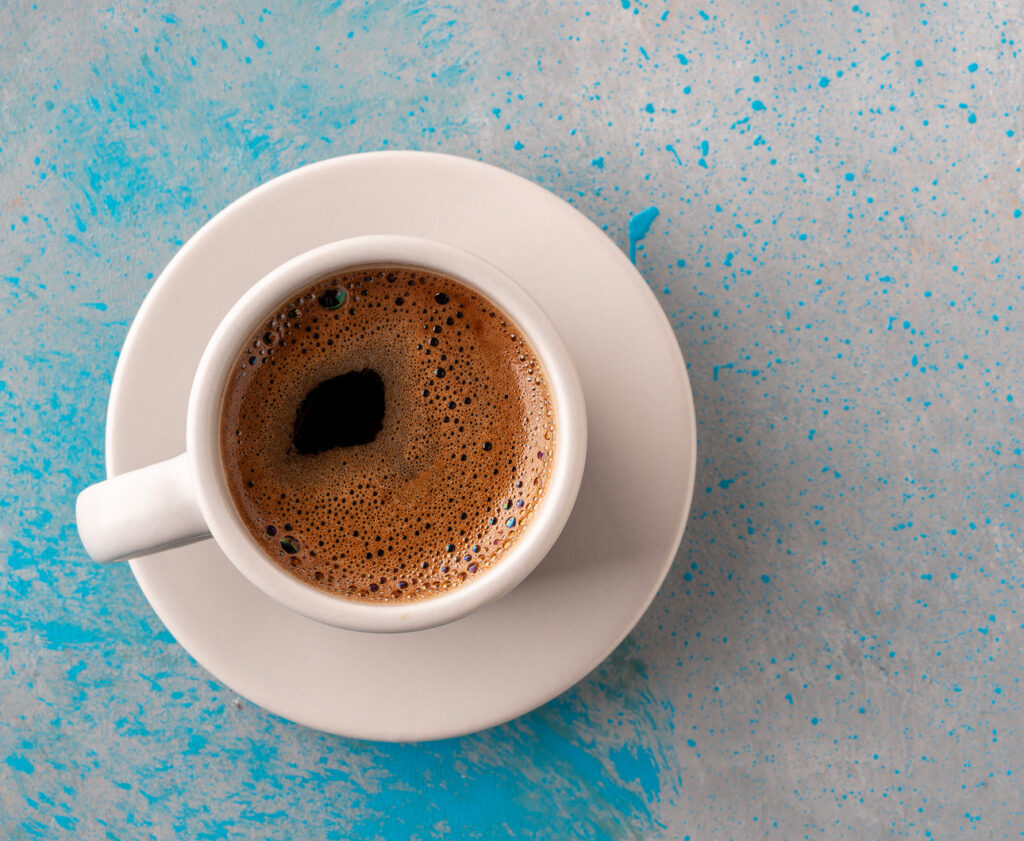 Cup of coffee on a blue tabletop
