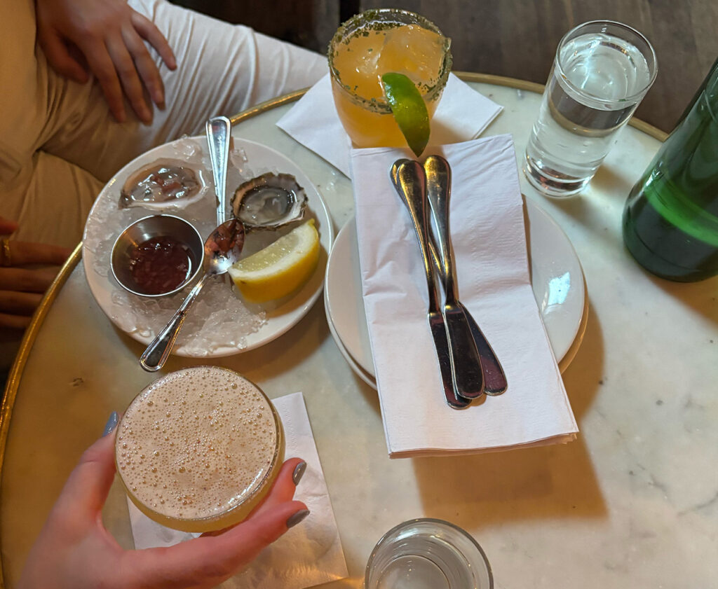 Shared plates and drinks arranged on a dining table