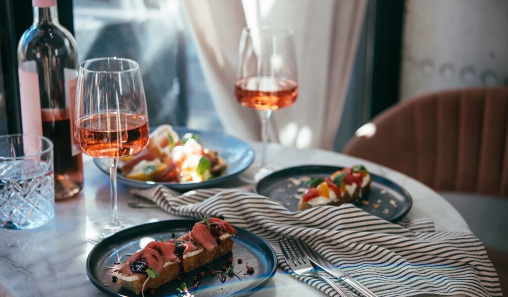 Colorful plated dishes served with wine