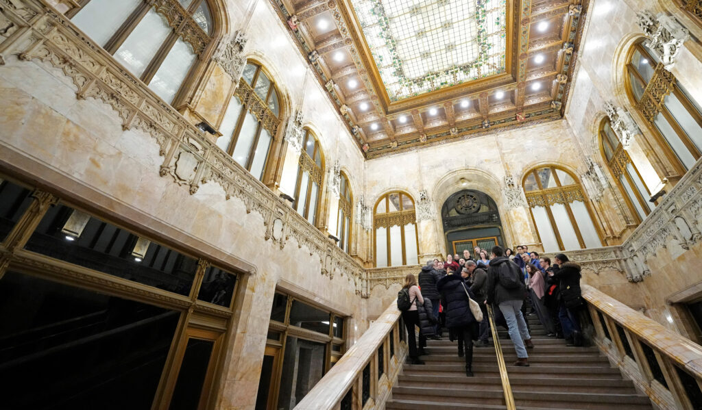 Guests descend the ornate Woolworth Building lobby staircase