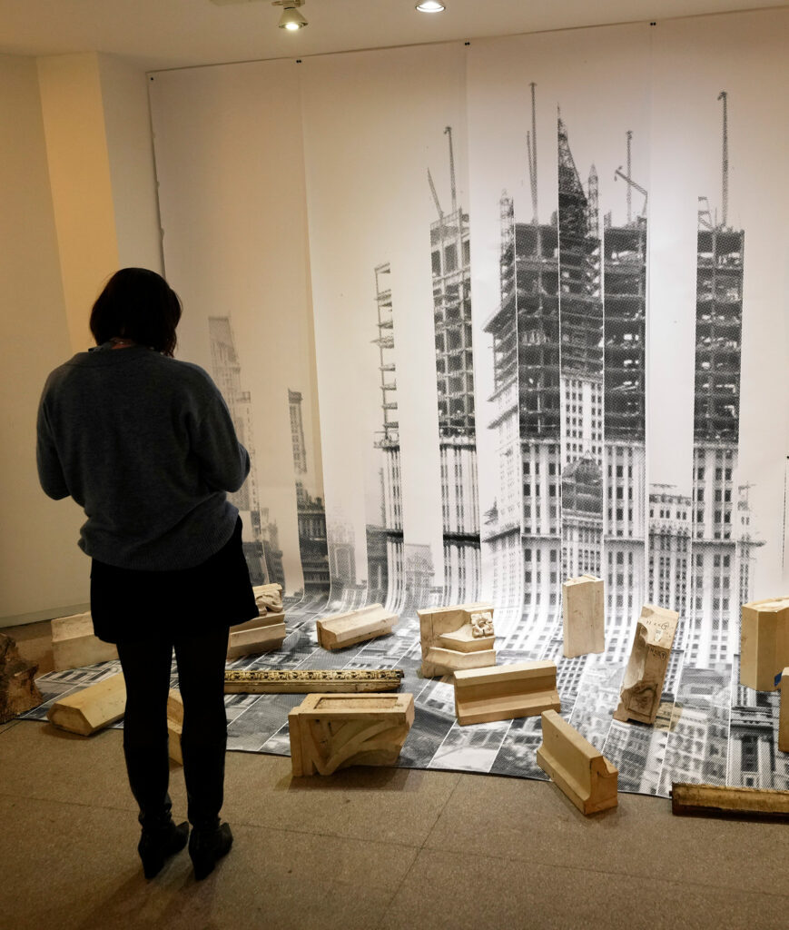 Visitor studies an architectural exhibition at The Woolworth