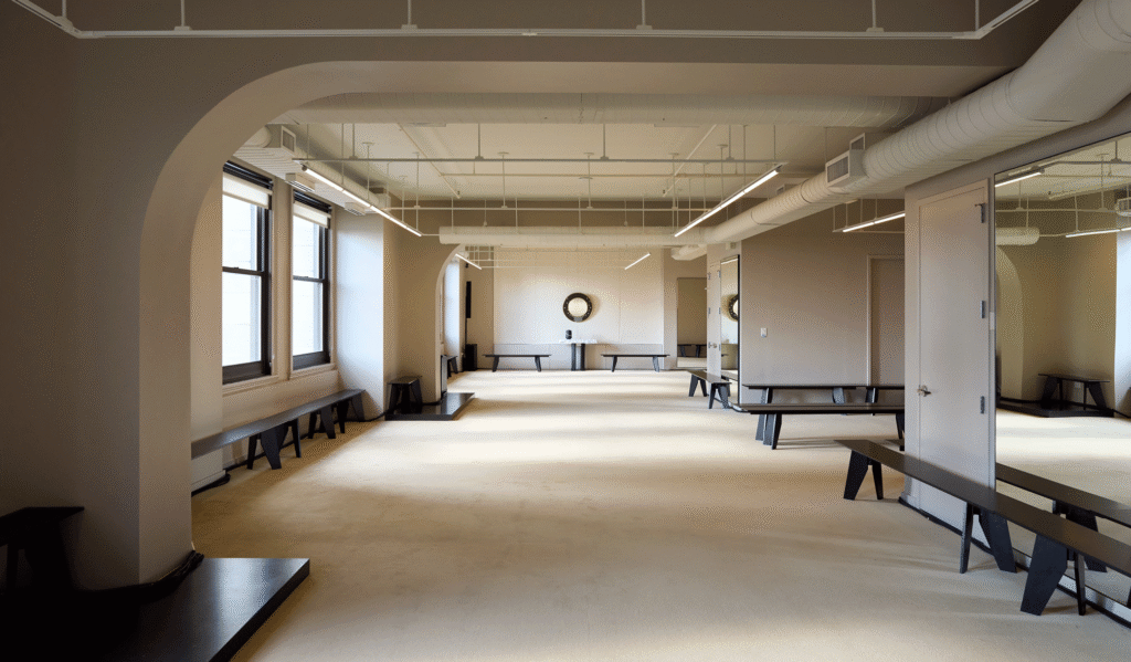Altuzarra's open studio floor with arched openings and long working benches