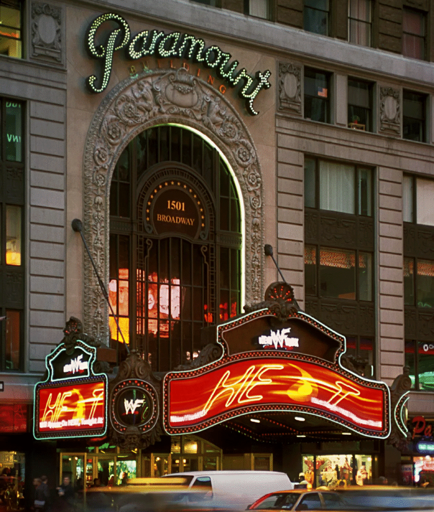 The illuminated marquee and ornate entrance arch of the Paramount Building at 1501 Broadway